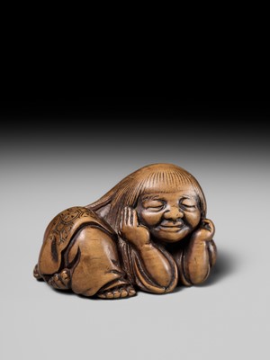 Lot 192 - YOSHIOKI: A SUPERB WOOD NETSUKE OF A SLEEPING SHOJO