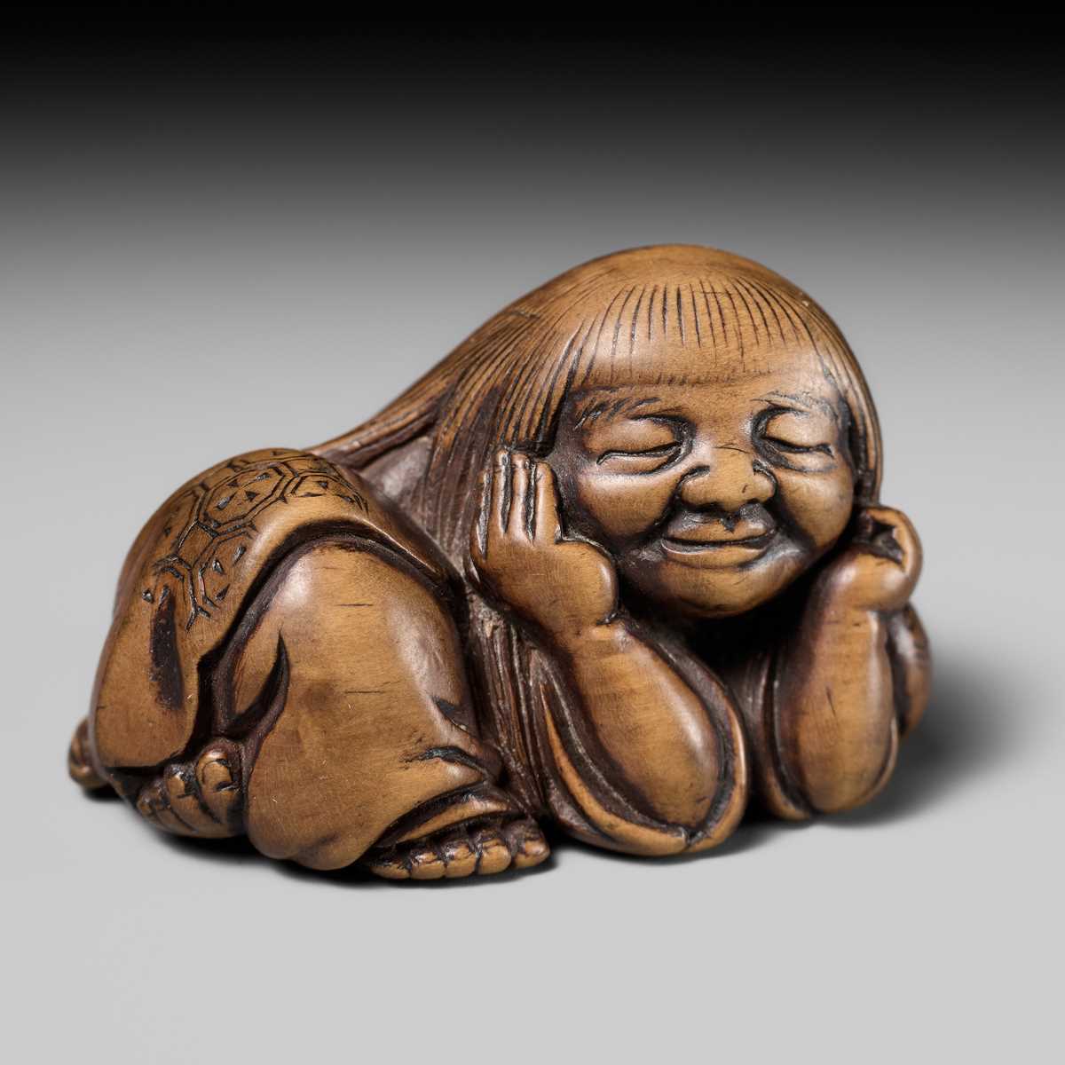 Lot 192 - YOSHIOKI: A SUPERB WOOD NETSUKE OF A SLEEPING SHOJO