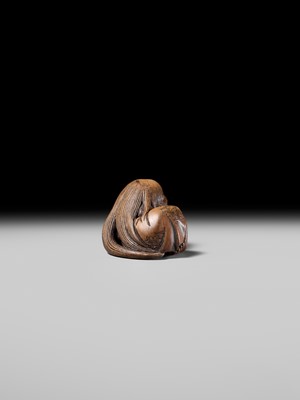 Lot 192 - YOSHIOKI: A SUPERB WOOD NETSUKE OF A SLEEPING SHOJO