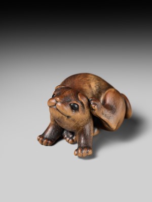 Lot 162 - NAITO TOYOMASA: A SUPERB WOOD NETSUKE OF A PUPPY SCRATCHING ITSELF