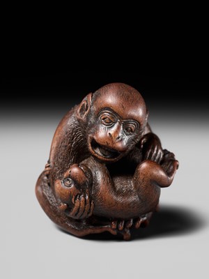 Lot 114 - MASANAO: A SUPERB WOOD NETSUKE OF A MONKEY WITH YOUNG