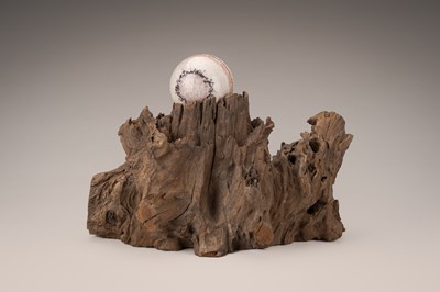 Lot 759 - AN AGAR WOOD ‘SCHOLAR’S ROCK’ WITH A SPHERE, QING