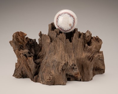 Lot 759 - AN AGAR WOOD ‘SCHOLAR’S ROCK’ WITH A SPHERE, QING