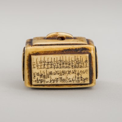 Lot 1253 - AN ANTLER NETSUKE OF A BOX WITH INSCRIPTIONS