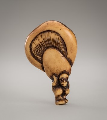 Lot 1259 - AN ANTLER NETSUKE OF A SMALL MONKEY CARRYING A LARGE MUSHROOM