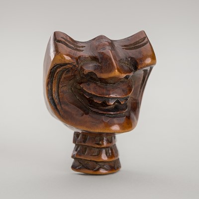 Lot 1429 - A WOOD NETSUKE OF A RESSEI MENPO (HALF MASK)