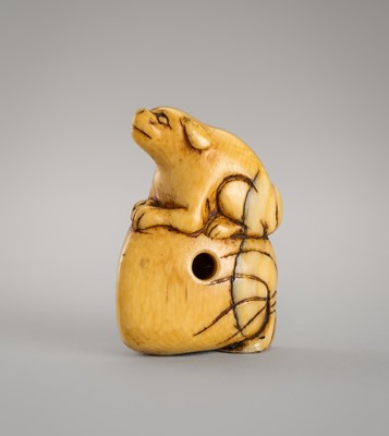 Lot 1297 - AN IVORY NETSUKE OF A DOG ON A SACK