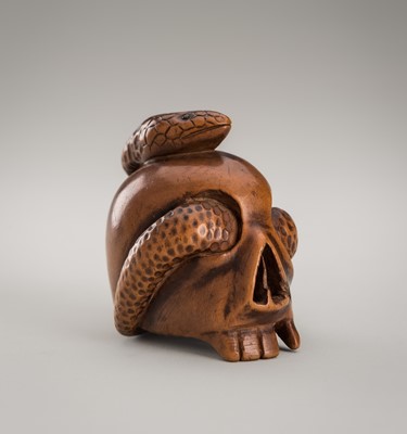 Lot 1335 - A WOOD OKIMONO-NETSUKE OF A SNAKE AND SKULL