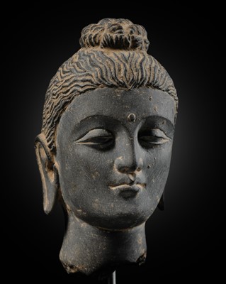 Lot 383 - A GRAY SCHIST HEAD OF BUDDHA SHAKYAMUNI, ANCIENT REGION OF GANDHARA