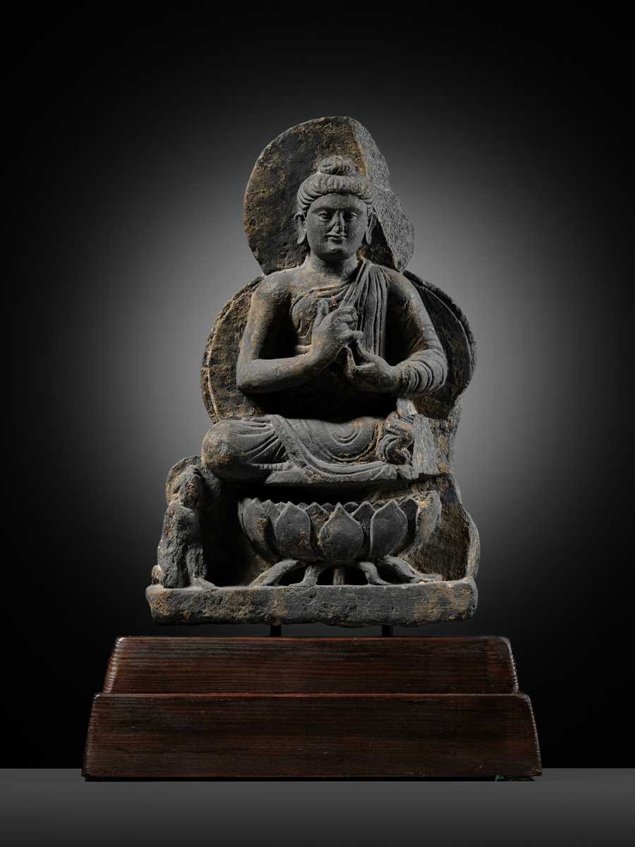 Lot 391 - A GRAY SCHIST FIGURE OF BUDDHA TEACHING HIS