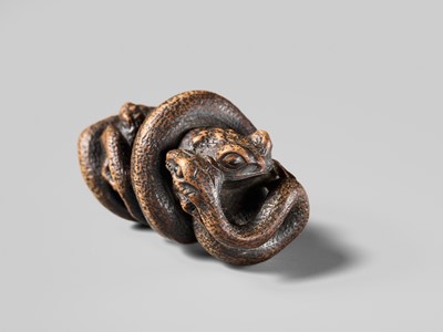 Lot 120 - MASANAO: A FINE WOOD NETSUKE OF A SNAKE PREYING ON A FROG, SANSUKUMI