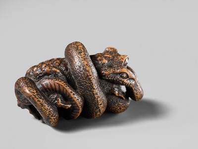 Lot 120 - MASANAO: A FINE WOOD NETSUKE OF A SNAKE PREYING ON A FROG, SANSUKUMI