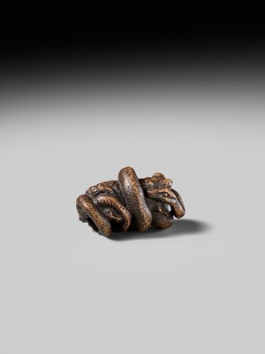 Lot 120 - MASANAO: A FINE WOOD NETSUKE OF A SNAKE PREYING ON A FROG, SANSUKUMI