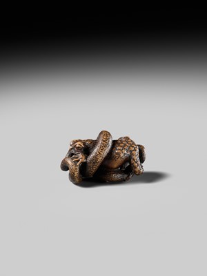 Lot 120 - MASANAO: A FINE WOOD NETSUKE OF A SNAKE PREYING ON A FROG, SANSUKUMI