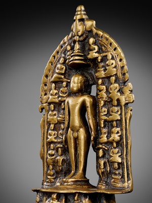 Lot 340 - A JAIN BRASS SHRINE OF THE TWENTY-FOUR TIRTHANKARA WITH MAHAVIRA, WESTERN INDIA, 15TH-16TH CENTURY