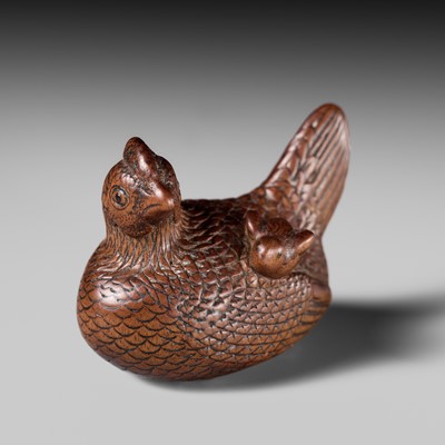 TOMOTSUNE: A SUPERB NAGOYA SCHOOL WOOD NETSUKE OF A HEN WITH TWO CHICKS