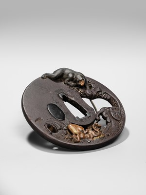 Lot 62 - AN INGENIOUS TETSUGENDO SCHOOL IRON TSUBA WITH A MONKEY CATCHING AN OCTOPUS