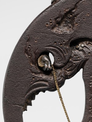 Lot 62 - AN INGENIOUS TETSUGENDO SCHOOL IRON TSUBA WITH A MONKEY CATCHING AN OCTOPUS