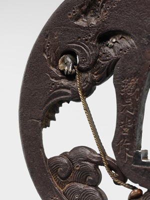 Lot 62 - AN INGENIOUS TETSUGENDO SCHOOL IRON TSUBA WITH A MONKEY CATCHING AN OCTOPUS