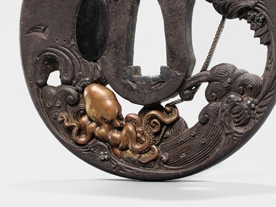 Lot 62 - AN INGENIOUS TETSUGENDO SCHOOL IRON TSUBA WITH A MONKEY CATCHING AN OCTOPUS