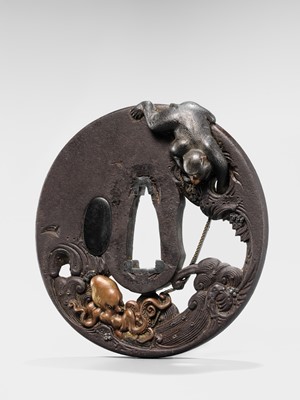 Lot 62 - AN INGENIOUS TETSUGENDO SCHOOL IRON TSUBA WITH A MONKEY CATCHING AN OCTOPUS