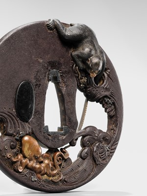 Lot 62 - AN INGENIOUS TETSUGENDO SCHOOL IRON TSUBA WITH A MONKEY CATCHING AN OCTOPUS