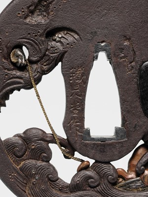 Lot 62 - AN INGENIOUS TETSUGENDO SCHOOL IRON TSUBA WITH A MONKEY CATCHING AN OCTOPUS