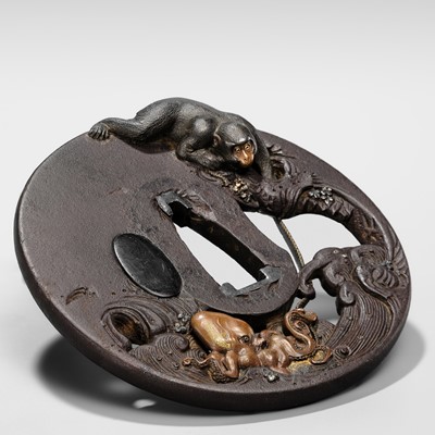 Lot 62 - AN INGENIOUS TETSUGENDO SCHOOL IRON TSUBA WITH A MONKEY CATCHING AN OCTOPUS