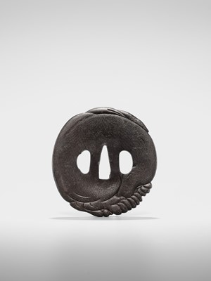 Lot 65 - A SUPERB IRON TSUBA OF A PUPPY WITH GOLD-INLAID EYES