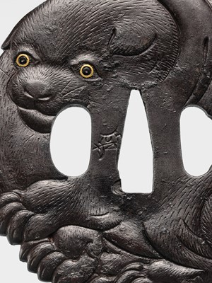 Lot 65 - A SUPERB IRON TSUBA OF A PUPPY WITH GOLD-INLAID EYES