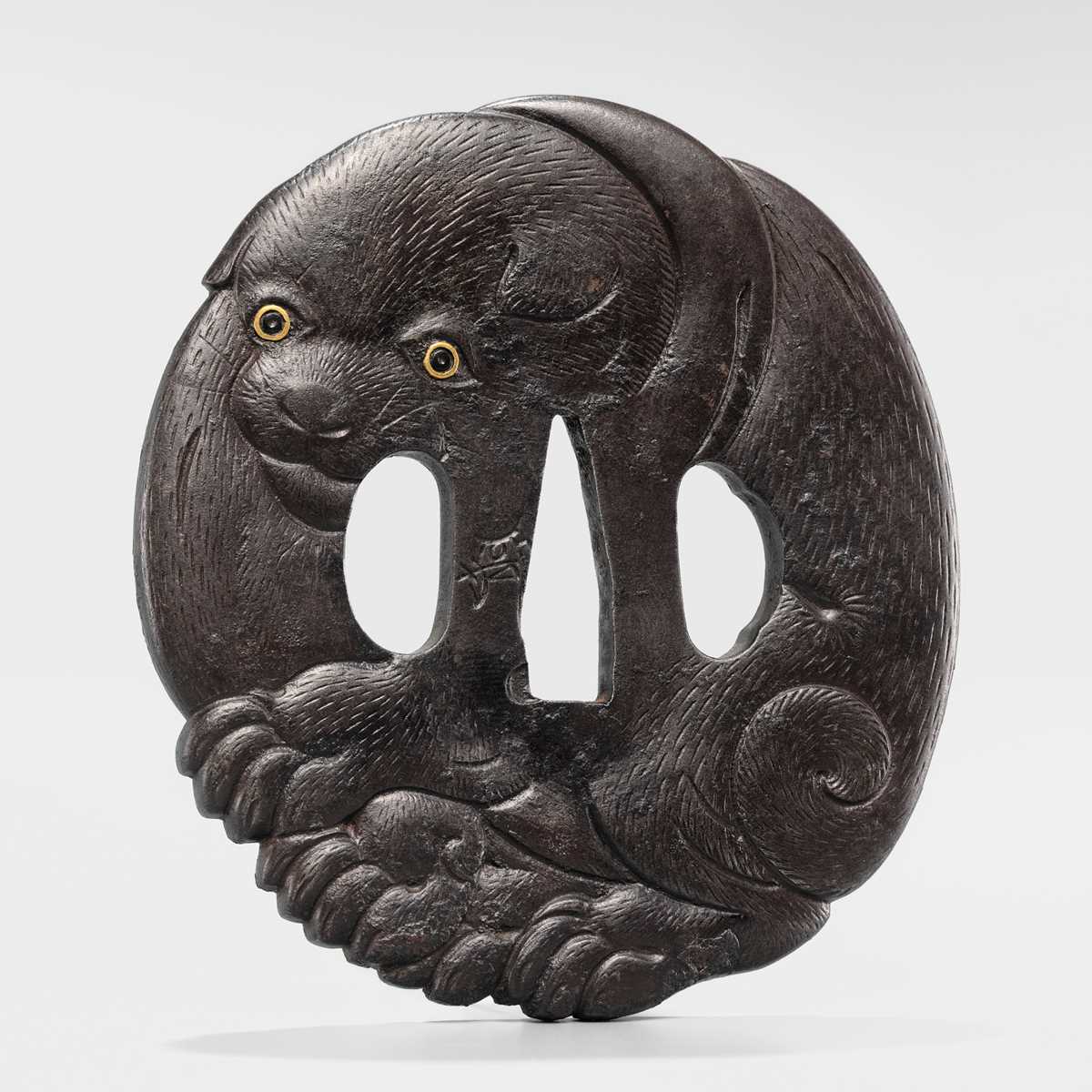 Lot 65 - A SUPERB IRON TSUBA OF A PUPPY WITH GOLD-INLAID EYES
