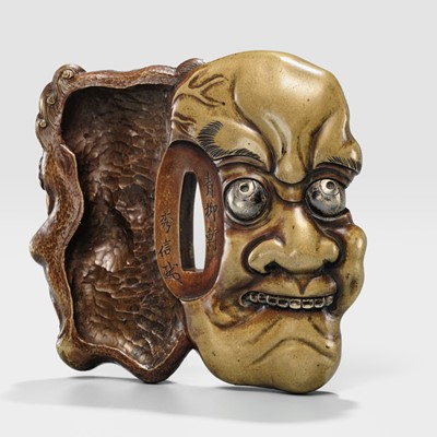 Lot 70 - SEIRYUKEN HIDENOBU: A LARGE AND SUPERB SENTOKU AND SUAKA MITO SCHOOL ‘ONI AND OBESHIMI MASK’ TSUBA