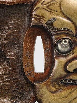 Lot 70 - SEIRYUKEN HIDENOBU: A LARGE AND SUPERB SENTOKU AND SUAKA MITO SCHOOL ‘ONI AND OBESHIMI MASK’ TSUBA