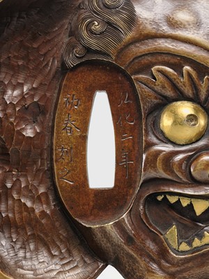 Lot 70 - SEIRYUKEN HIDENOBU: A LARGE AND SUPERB SENTOKU AND SUAKA MITO SCHOOL ‘ONI AND OBESHIMI MASK’ TSUBA