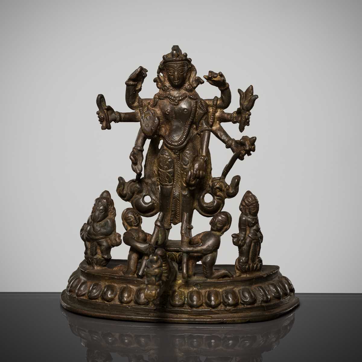 Lot 307 - A BRONZE GROUP OF AMOGHAPASA LOKESHVARA WITH GANESHA, TARA, AND ATTENDANTS, NEPAL OR HIMACHAL PRADESH, 18TH-19TH CENTURY