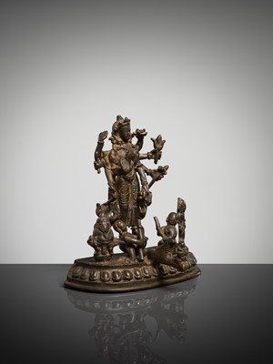 Lot 307 - A BRONZE GROUP OF AMOGHAPASA LOKESHVARA WITH GANESHA, TARA, AND ATTENDANTS, NEPAL OR HIMACHAL PRADESH, 18TH-19TH CENTURY