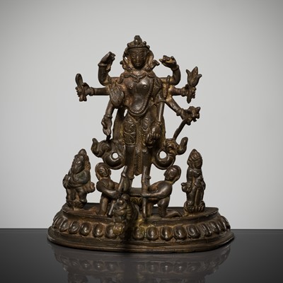Lot 307 - A BRONZE GROUP OF AMOGHAPASA LOKESHVARA WITH GANESHA, TARA, AND ATTENDANTS, NEPAL OR HIMACHAL PRADESH, 18TH-19TH CENTURY