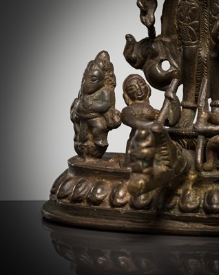 Lot 307 - A BRONZE GROUP OF AMOGHAPASA LOKESHVARA WITH GANESHA, TARA, AND ATTENDANTS, NEPAL OR HIMACHAL PRADESH, 18TH-19TH CENTURY