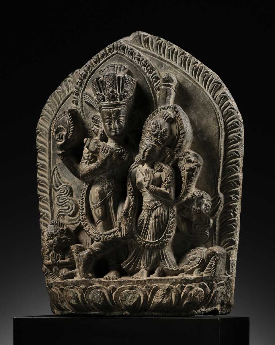 Lot 298 - A GRAY STONE STELE OF VISHNU AND LAKSHMI, NEPAL, 15TH-16TH CENTURY