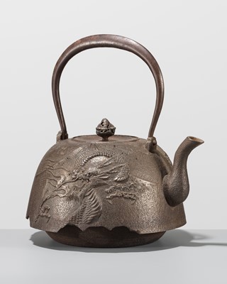 Lot 64 - NAKAMURA TOKUJIRO: A NANBU WARE IRON TETSUBIN (TEA KETTLE) DEPICTING A DRAGON