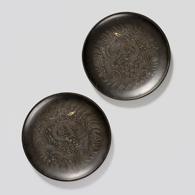 Lot 28 - A PAIR OF METAL DISHES DEPICTING FIERCE DRAGONS