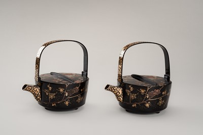 Lot 129 - A PAIR OF BLACK AND GOLD LACQUER CHOSHI (SAKE EWERS) AND COVERS