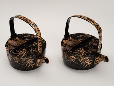 Lot 129 - A PAIR OF BLACK AND GOLD LACQUER CHOSHI (SAKE EWERS) AND COVERS