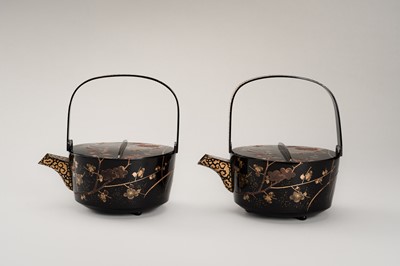 Lot 129 - A PAIR OF BLACK AND GOLD LACQUER CHOSHI (SAKE EWERS) AND COVERS