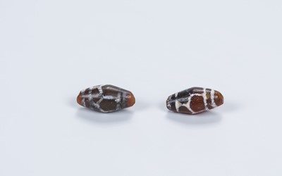 Lot 1794 - A PAIR OF SMALL ANTIQUE TIBETAN AGATE ‘CHUNG DZI’ BEADS