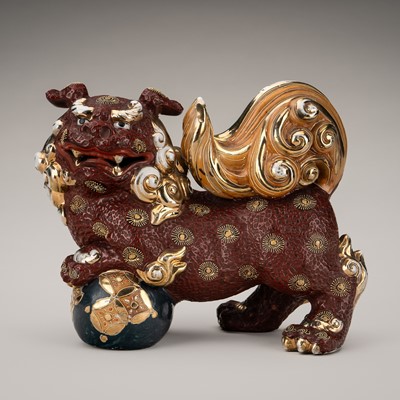 Lot 205 - AN IMARI PORCELAIN FIGURE OF A SHISHI WITH BALL