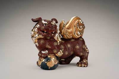 Lot 205 - AN IMARI PORCELAIN FIGURE OF A SHISHI WITH BALL