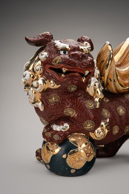 Lot 205 - AN IMARI PORCELAIN FIGURE OF A SHISHI WITH BALL