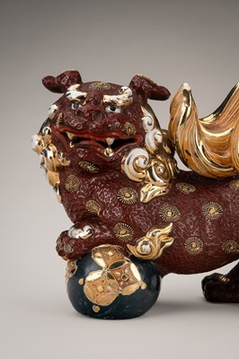 Lot 205 - AN IMARI PORCELAIN FIGURE OF A SHISHI WITH BALL