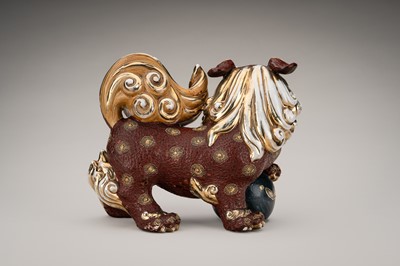 Lot 205 - AN IMARI PORCELAIN FIGURE OF A SHISHI WITH BALL